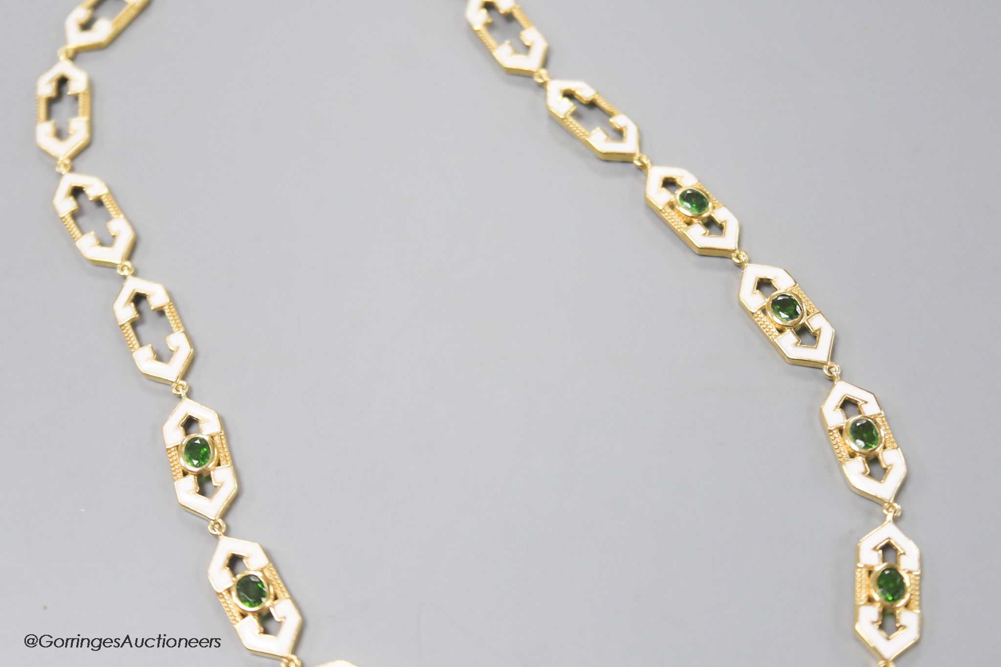 A modern stylish 925 gilt white metal, green paste and enamel set necklace, 50cm